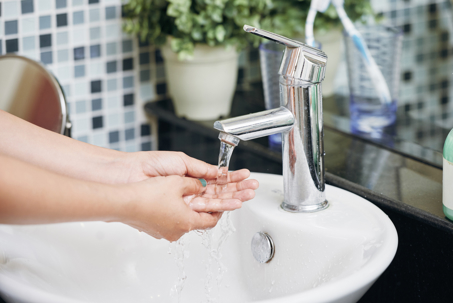 woman washing hands in soft water sink